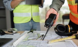 male engineer holding walkie talkie and civil engineer with working together inspection housing